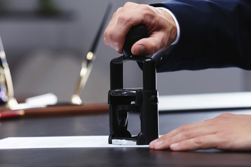 Notary public in office stamping document