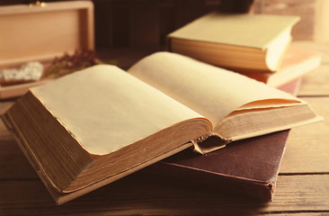 Old open book on wooden table, closeup