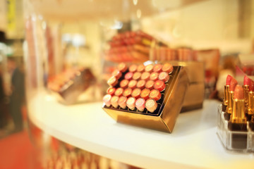 Stand with lipsticks in cosmetic store