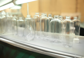 Stand with different containers for cosmetic products in retail shop