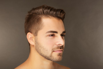 Obraz premium Portrait of young handsome man on grey background