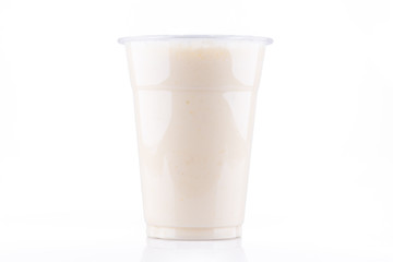 Frontal view of banana milkshake in plastic cup