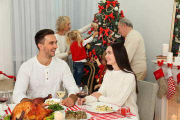 Happy family celebrating Christmas in living room