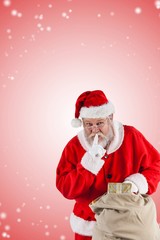 Fototapeta na wymiar Composite image of santa claus with finger on lips and holding g