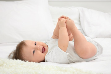 Obraz na płótnie Canvas Cute baby lying on bed