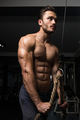 Fototapeta na wymiar Muscular Man Exercising Triceps