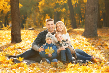 Happy family resting in beautiful autumn park