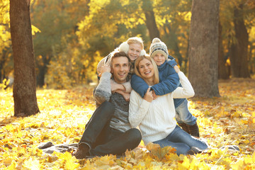 Happy family resting in beautiful autumn park