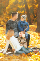 Fototapeta premium Happy family resting in beautiful autumn park