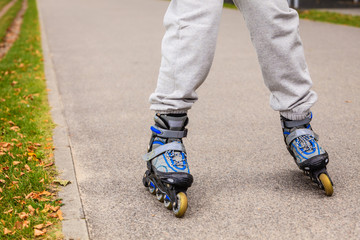 Fototapeta na wymiar Human legs rollerblading wearing sportswear.