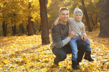 Father and son in beautiful autumn park