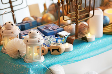 Menorah and decorative elements near mirror, closeup. Hanukkah concept © Africa Studio