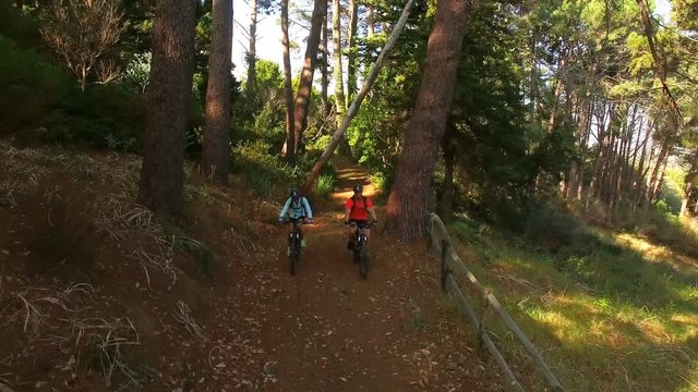 Hiker couple cycling in the forest