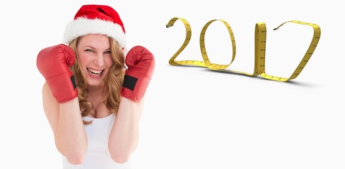 Composite image of blonde woman wearing boxing gloves smiling at