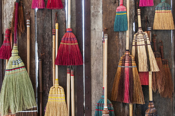 Colorful broom on the wodden wall