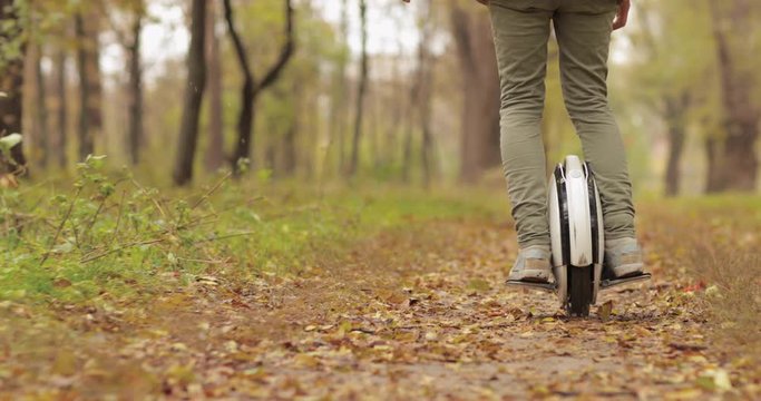 Man riding mono wheel personal electrical transport street outdoor