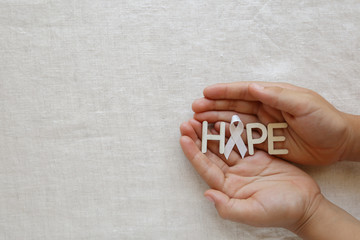 HOPE and white ribbon on hands, Bone cancer awareness, Multiple Hereditary Exostoses, Postpartum...