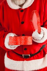 Composite image of midsection of santa claus opening gift box