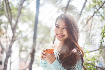 Portrait of a young asian woman drinking her morning tea. Fell r