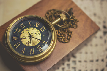 old pocket watch with chain on box wood  vintage tone