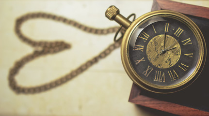 old pocket watch with chain in heart shape vintage tone