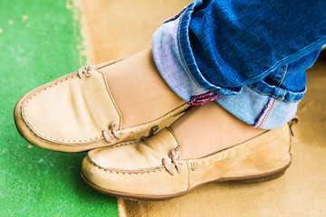 Close up of stylish female shoes. Outdoor fashion shoes footwear concept,Woman's legs in blue jeans.