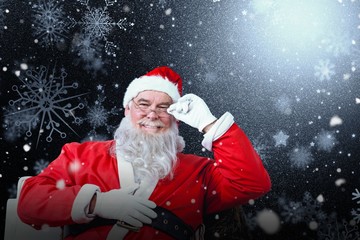 Composite image of smiling santa claus sitting on chair