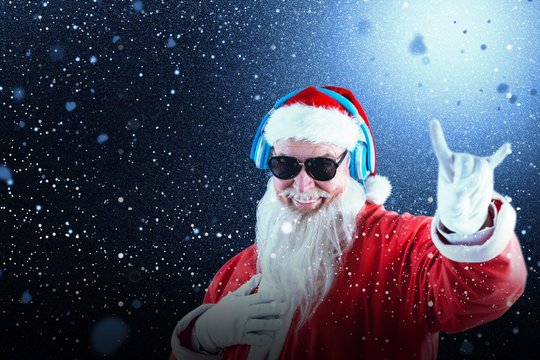 Composite image of santa claus showing horn sign while listening