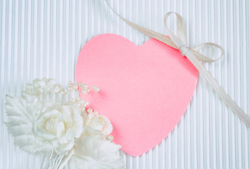 boutonniere, pink heart shaped tag, white silk ribbon