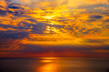 Naklejka na ściany i meble Sunset over sea with reflection