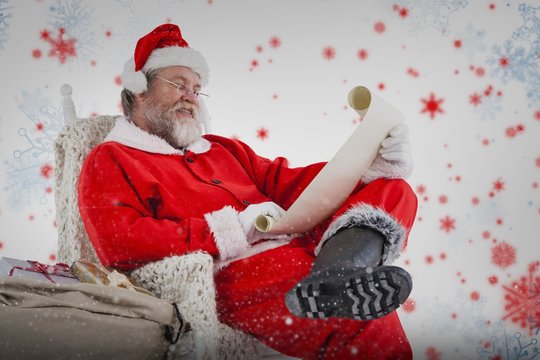 Composite image of santa claus reading wish list on scroll again
