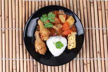 Rice with boiled chicken,omelet roll topped Japanese yellow curr