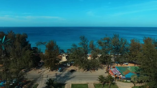 Aerial: Temple next to the sea near Surin beach.