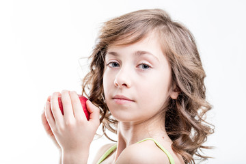 girl about to bite a red apple on white background