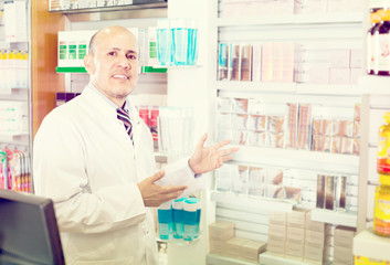 Naklejka na ściany i meble Male pharmacist working in farmacy