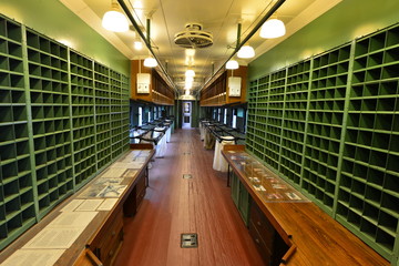 The interior of a vintage mail car in America.
