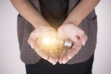 Business hand holding light bulb concept of new ideas with new innovation and new creativity.