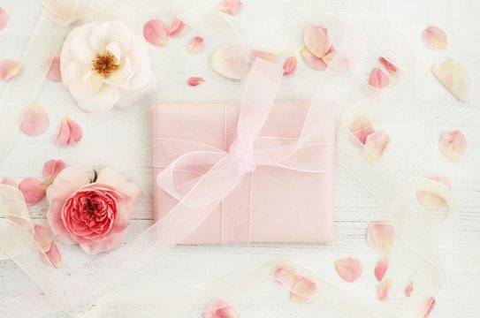 
Floral decorated handmade pink paper feminine	 gift, delicate lovely rose flowers and petals, pastel tones.