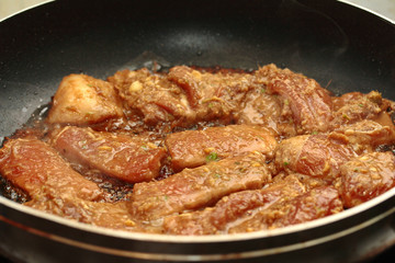 Cooking grilled pork with mixed herb served.  Selective focus.