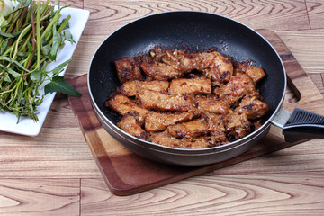 Ready grilled pork with mixed herb in pan  served.