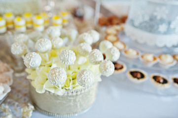 Wedding cakes and candies on reception table.
