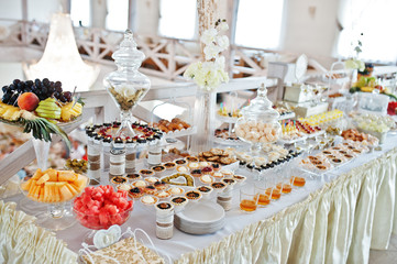 Wedding reception with different sweets and fruits.