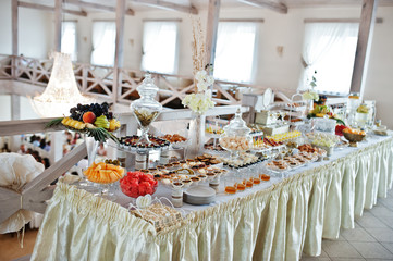 Wedding reception with different sweets and fruits.
