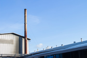 Fototapeta na wymiar Bio power plant with storage of wooden fuel against blue sky