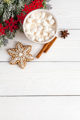 Christmas gingerbread, spruce branches on wooden background top view
