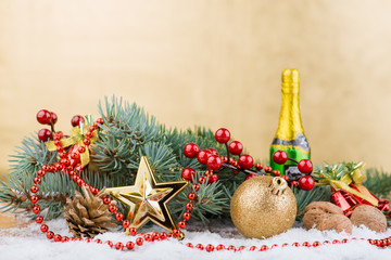 Christmas still life, spruce and cones, a ball, a bottle of cham
