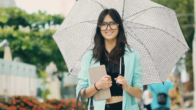 Beautiful asian young woman with tablet in city street