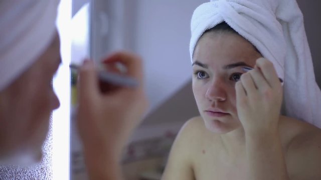 Woman Plucking Eyebrows With Tweezers
