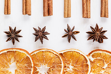 Christmas food - mulled wine background. Decorative frame of spice ingredients -  anise stars, cinnamon, dried oranges and wine on wood white surface. Top view.