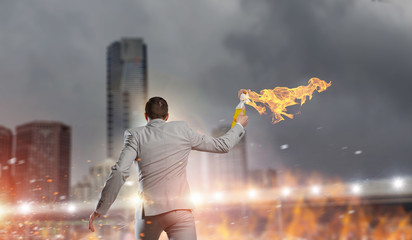 Businessman throwing petrol bomb . Mixed media